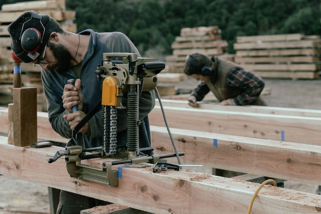 Expert carpenters and timberframers hard at work in the timber yard at Heritage Timbercraft, NZ