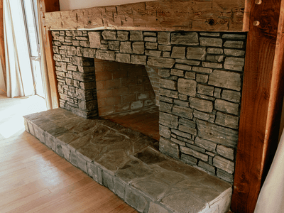 Large stone open fireplace in barn home