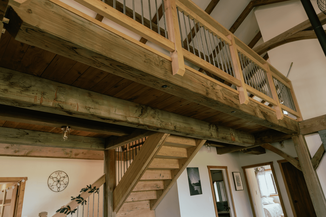 Reclaimed timber stairwell from antique U.S. barn. New Zealand grown Macrocarpa treads and hand forged metal balustrades