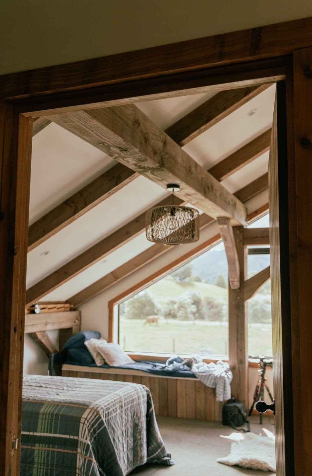 A spacious bedroom inside a contemporary kitset barn home made from NZ Douglas-fir and Macrocarpa timber