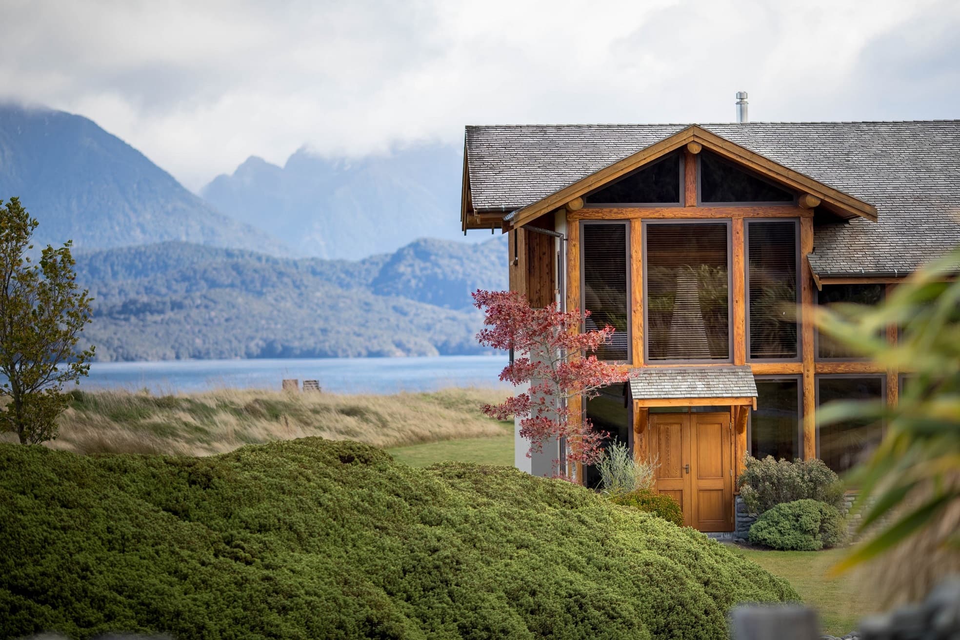 Panoramic lodge views framed by Douglas-fir timber construction at Fiordland Lodge
