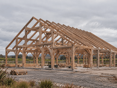 NZ timber frame event venue barn under construction using aged Douglas-fir timber