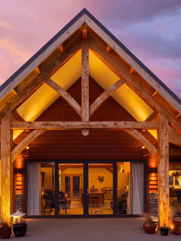 Exterior of a striking alpine timber frame hotel built with mortise and tenon joinery in Hanmer, NZ