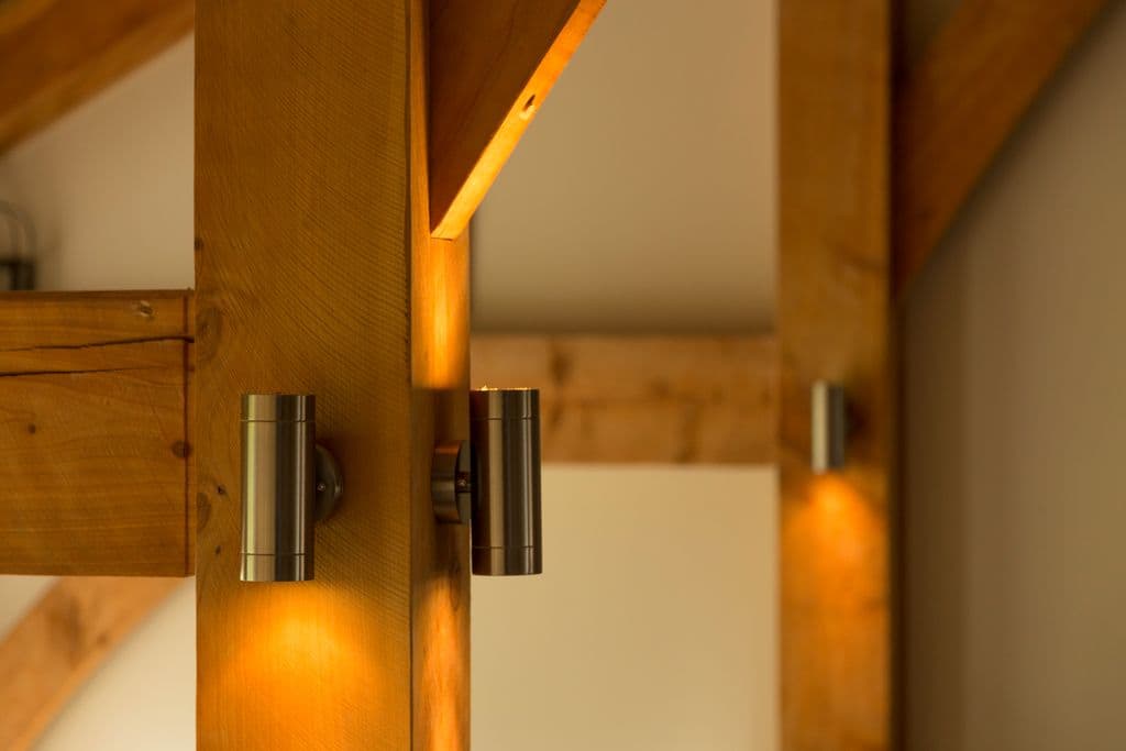 Highlight the quality timber and craftsmanship in a timber home with the use of stylish interior lighting