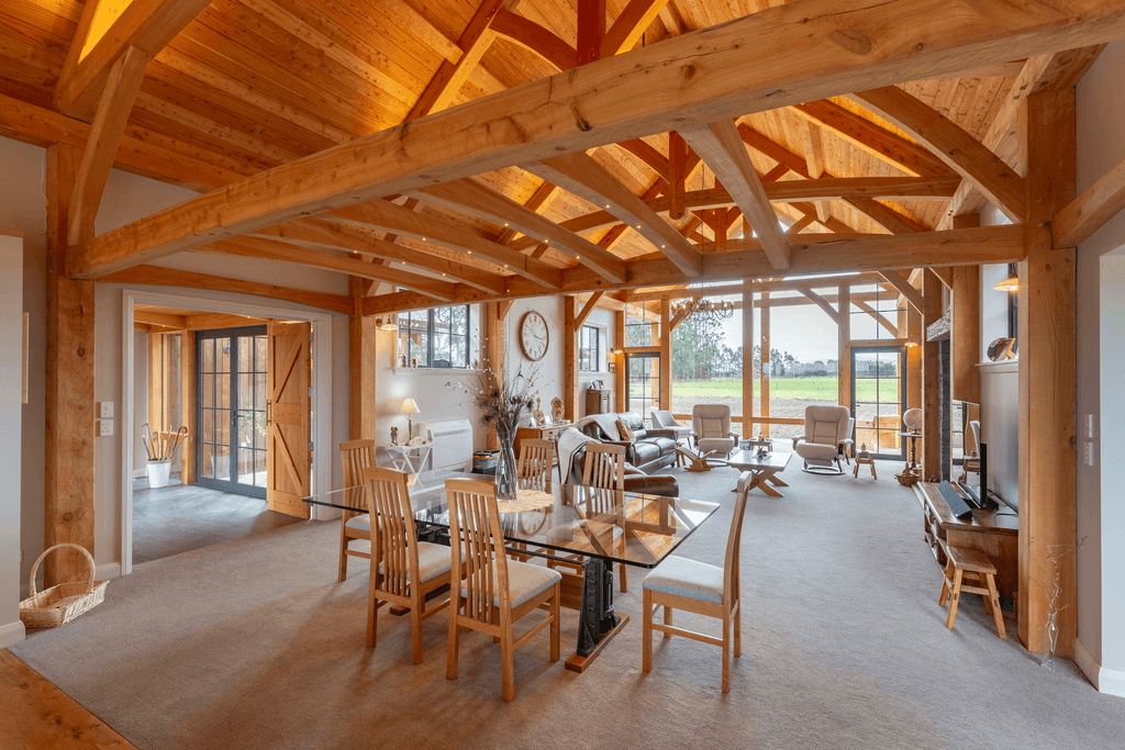 Luxury timber frame barn home with mortise and tenon joinery, sunroom, and rural lifestyle setting