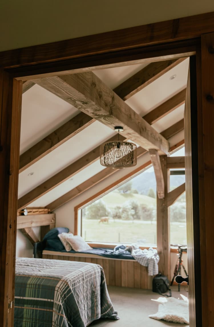 A spacious bedroom inside a contemporary kitset barn home made from NZ Douglas-fir and Macrocarpa timber