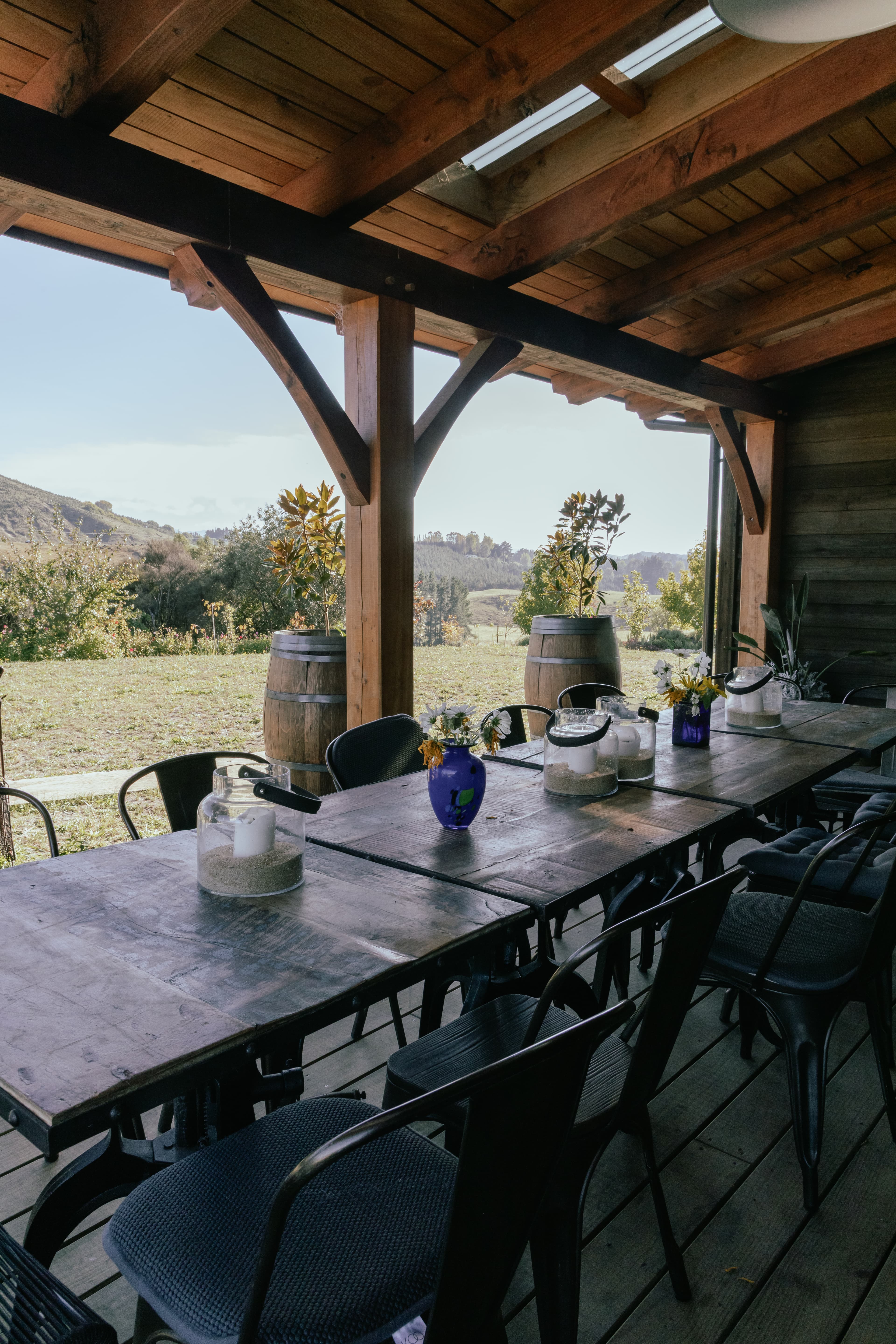 Elegant timber frame barn house with vaulted ceilings and river views - outdoor dining area